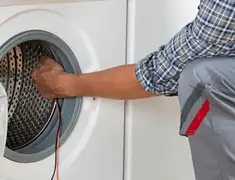 Dryer repair technician diagnosing and servicing a clothes dryer in Providence, RI