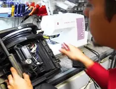 Vacuum repair technician servicing internal components on a workbench in Providence, RI