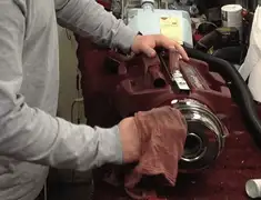 Vacuum repair technician cleaning and servicing a vacuum motor in Providence, RI