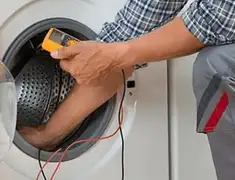 Washing machine repair technician testing a front-load washer with diagnostic tools in Providence, RI